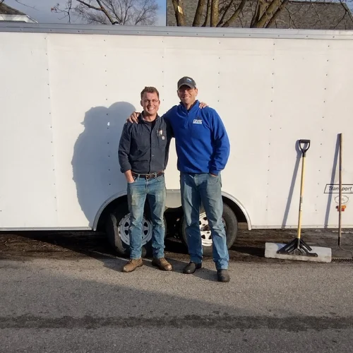 Level Sewer and Drain owners Levi and Josh standing by their work truck in La Crosse, WI