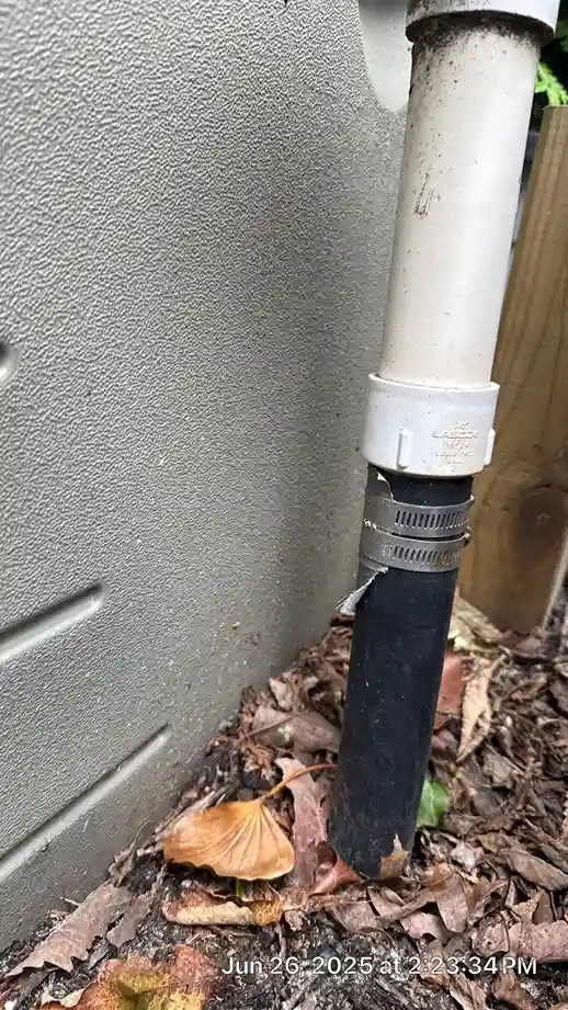 Cracked flexible pool pipe secured with a hose clamp at a pool equipment housing showing need for repair in Lakehurst, NJ by Gorlin Pools